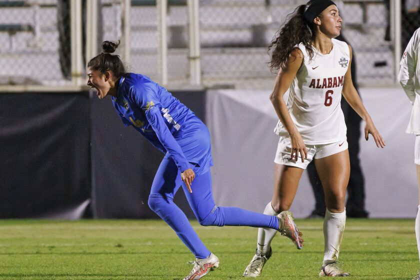 Madelyn Desiano (11) celebrates next to Alabama's Sasha Pickard (7) after scoring a goal during the second half of an NCAA women's soccer tournament semifinal in Cary, N.C., Friday, Dec. 2, 2022. (AP Photo/Ben McKeown)