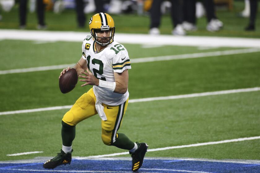 Green Bay Packers quarterback Aaron Rodgers looks downfield during the second half of an NFL football game against the Detroit Lions, Sunday, Dec. 13, 2020, in Detroit. (AP Photo/Leon Halip)