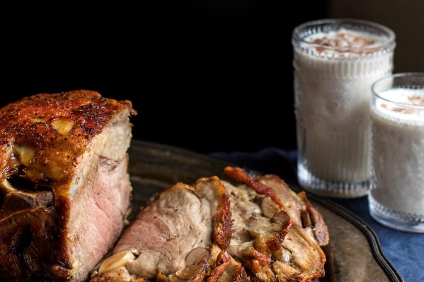 Illyanna Maisonet’s pernil seasoned with dried oregano and Goya Sazon Culantro y Achiote, served with a side of coquito, a Puerto Rican version of eggnog made with coconut milk, coconut cream and evaporated milk.