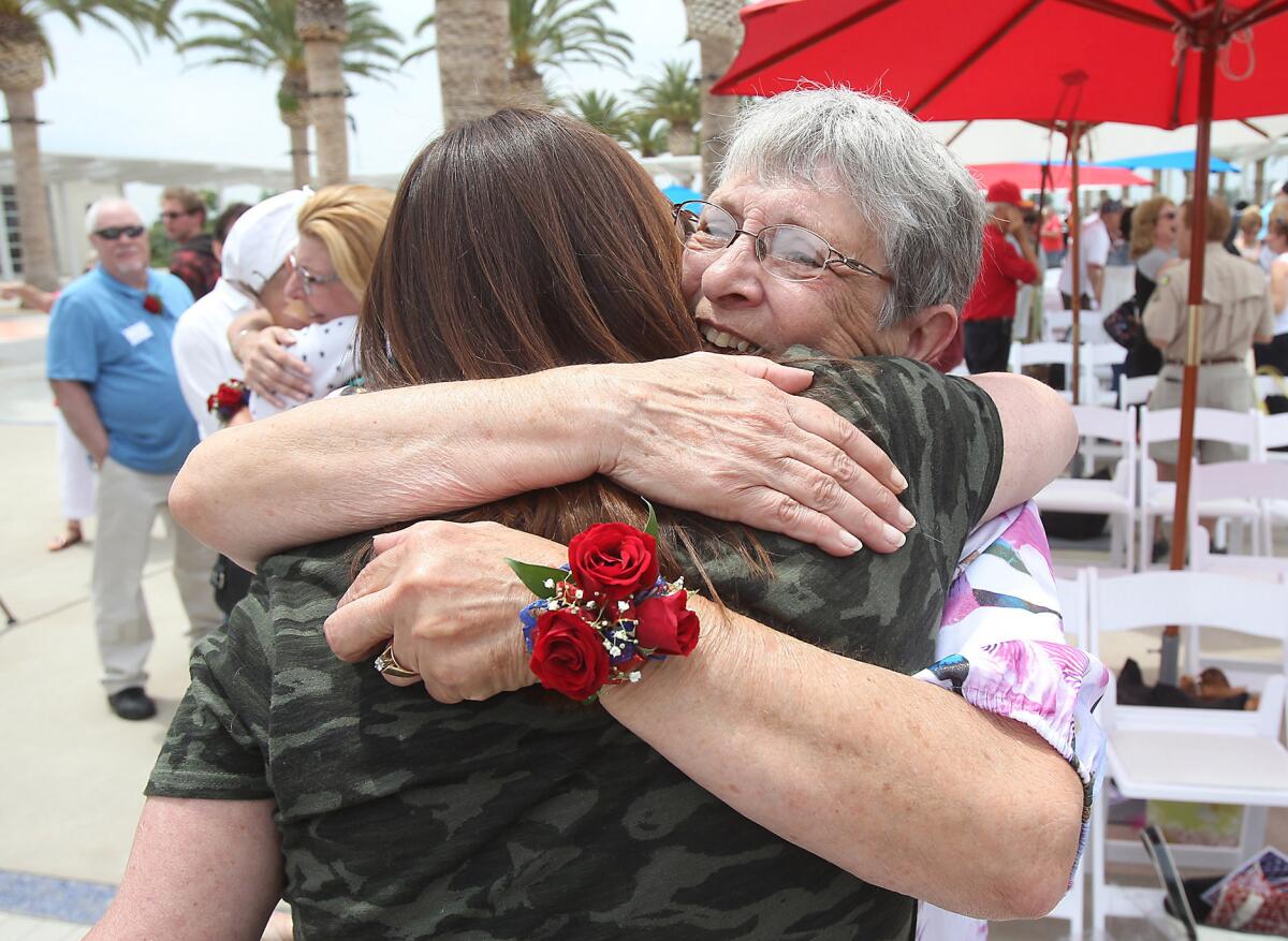 Susan Deardorff, right, hugs a lifelong friend during the 50th Anniversary Memorial Dedication and remembrance to the servicemen killed in the crash of a C-135 Marine Corps plane that left El Toro Marine Corp Air Station in 1965 bound for Vietnam. At the time, Deardorff was married to her husband Alfred "Fred" Peterson for only two weeks when he was killed in the accident on Loma Ridge in Orange County at what was then the El Toro Marine Corp Air Station.