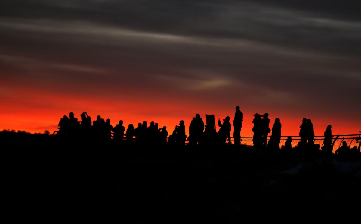 Visitors gather along Mather Point at Grand Canyon National Park to watch sunrise.