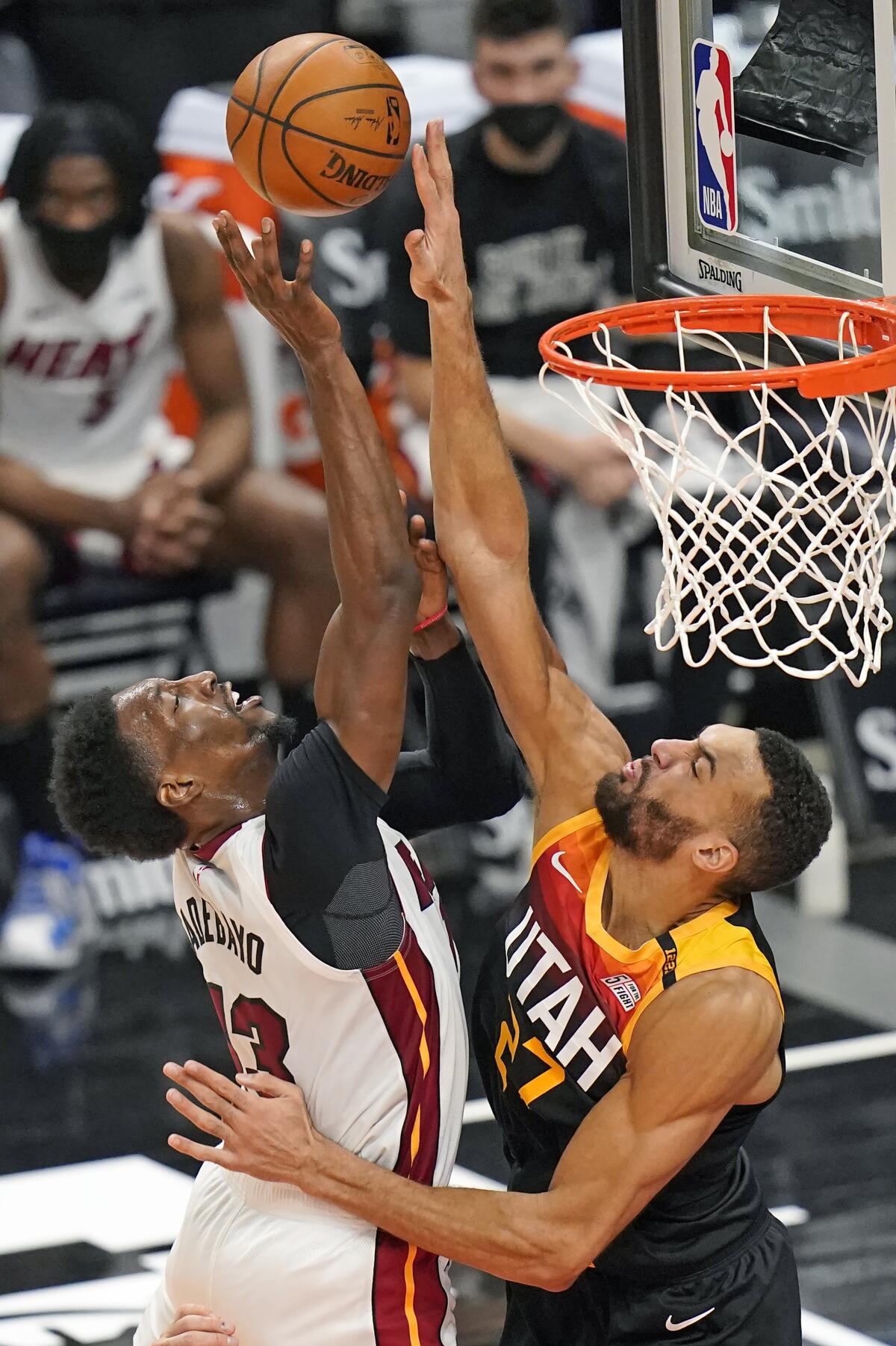 Utah Jazz center Rudy Gobert, right, blocks Miami Heat center Bam Adebayo.