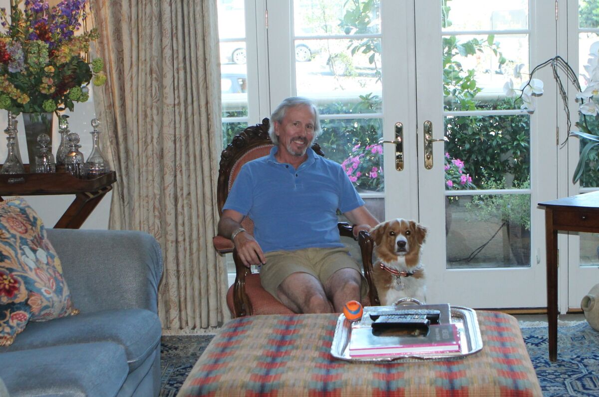 Jim Perry and his dog, Chilly, relax in their condo unit that once served as the hospital’s main lobby.