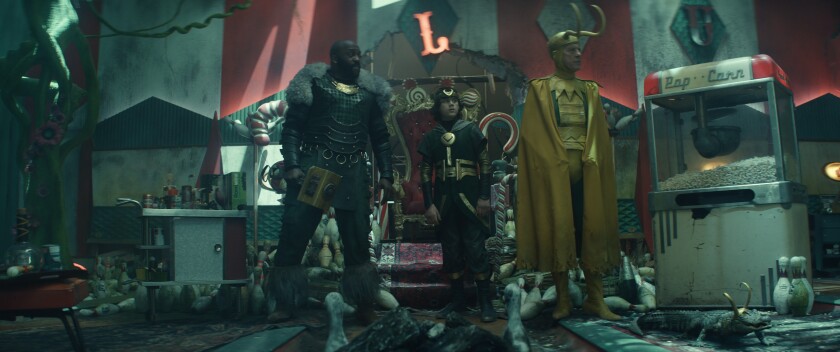 Three men and an alligator amid some junk.