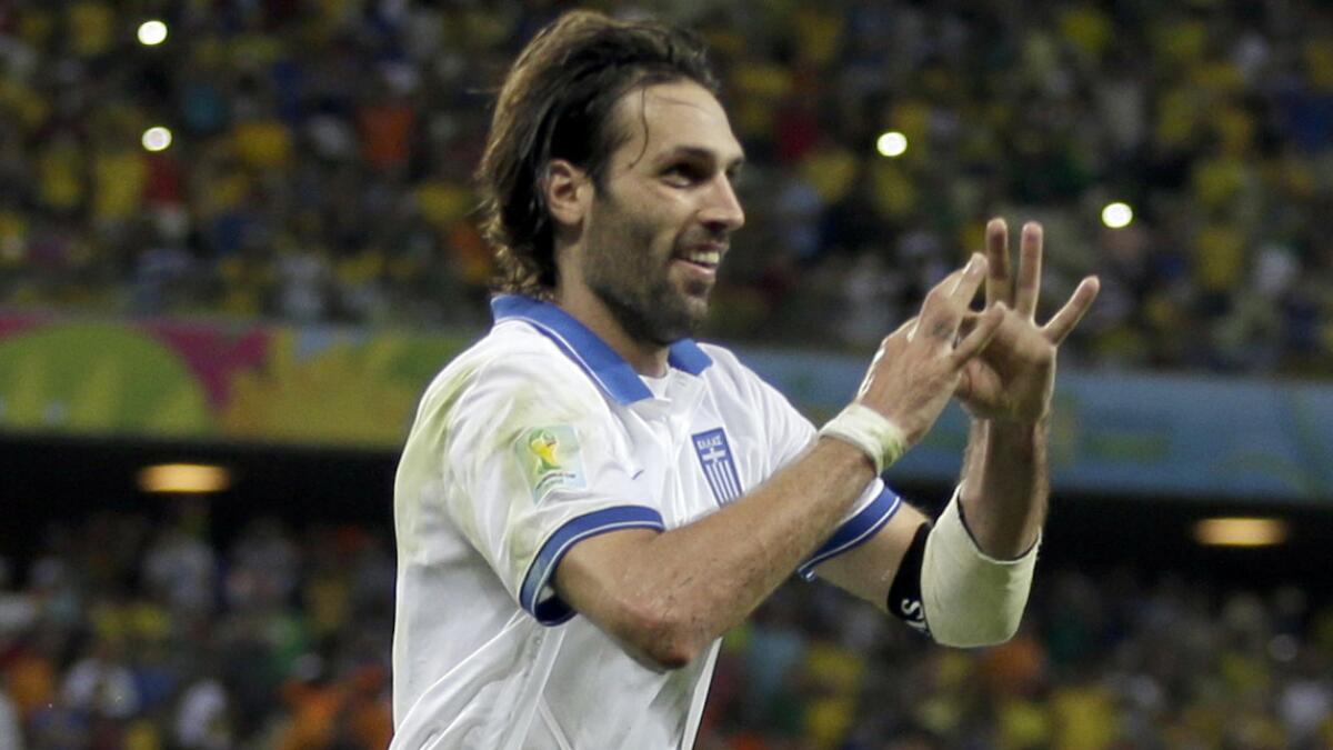 Greece's Giorgos Samaras celebrates after scoring the winning goal in stoppage time during the team's 2-1 World Cup win over Ivory Coast on Tuesday.