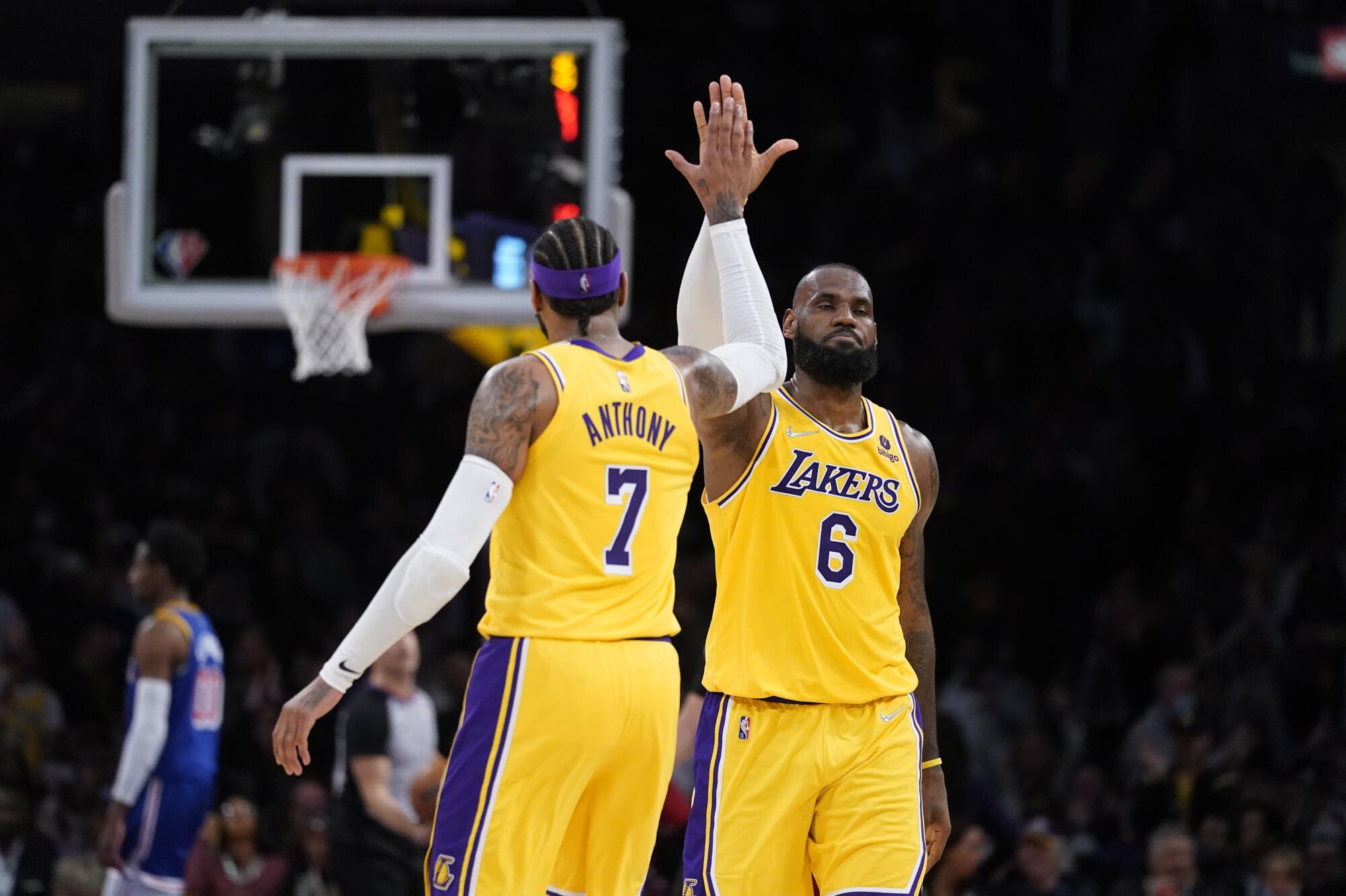 Lakers forward Carmelo Anthony, left, high-fives forward LeBron James during the second half.