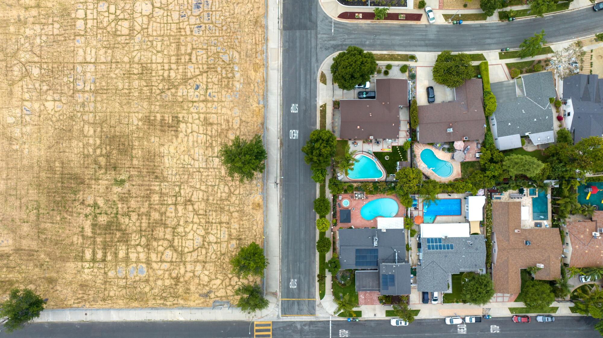 Six acres of vacant land, site of the former Oso Avenue Elementary School, left, is surrounded by single-family homes