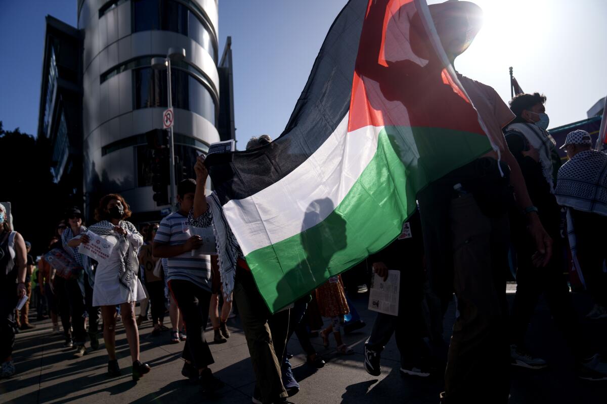 Pro-Palestinian protestors march outside the Biden fundraiser.
