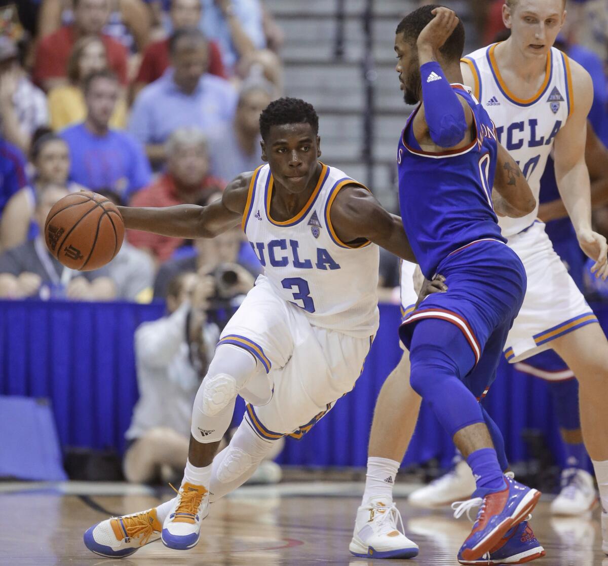 UCLA guard Aaron Holiday (3) drives around a Kansas defender during the first half of a game in the Maui Invitational.