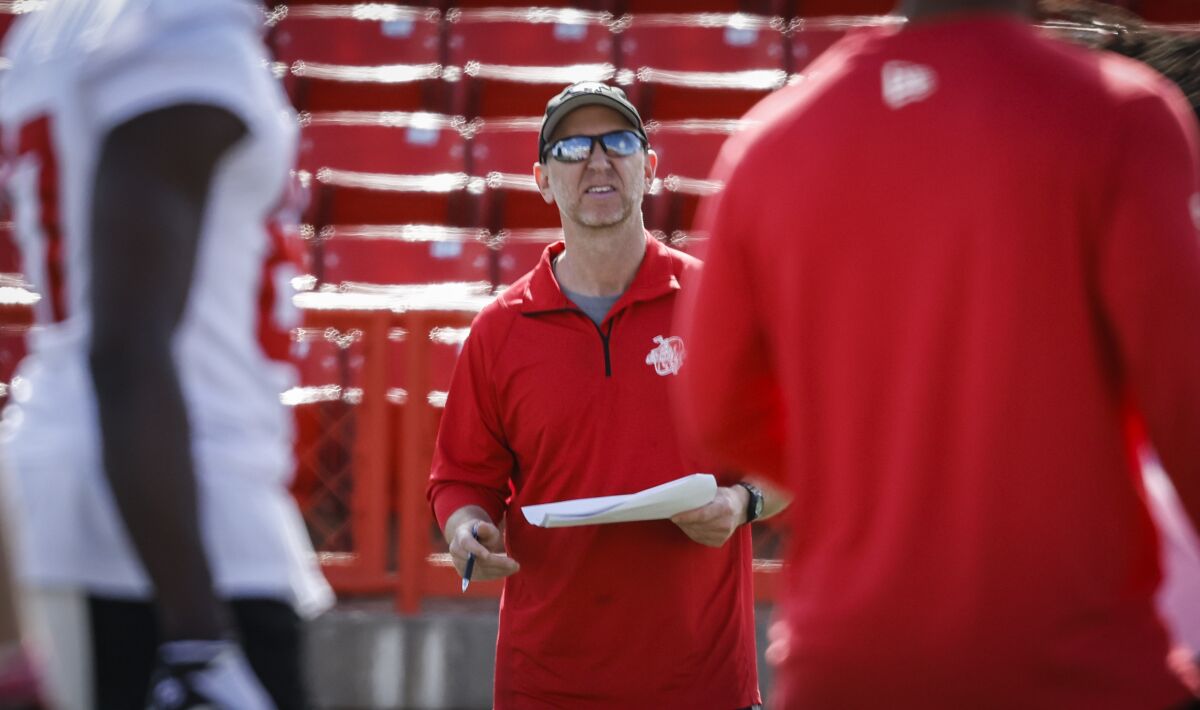 Calgary Stampeders head coach Dave Dickenson talks to players during opening day of the Canadian Football League team's training camp in Calgary, Alberta, Sunday, May 15, 2022. (Jeff McIntosh/The Canadian Press via AP)
