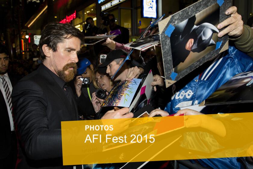 Actor Christian Bale takes pictures and signs autographs with fans lining Hollywood Boulevard before walking the red carpet for the premiere of "The Big Short" on the closing night of AFI.