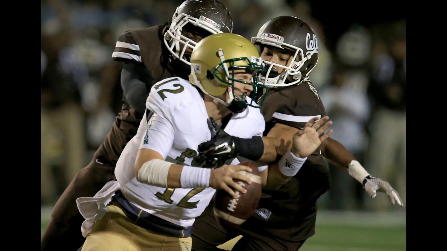 Long Beach Poly quarterback Josh Love is sacked by Crespi defender Spencer Silvers in the second quarter of their Pac-5 Division quarterfinal playoff game at Crespi Carmelite High in Encino.
