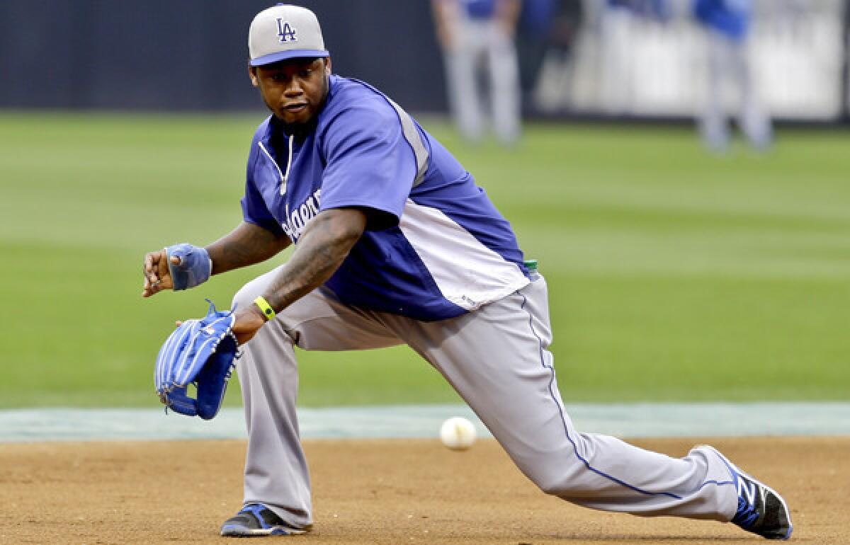 Dodgers shortstop Hanley Ramirez fields a grounder during a workout before a game in San Diego.