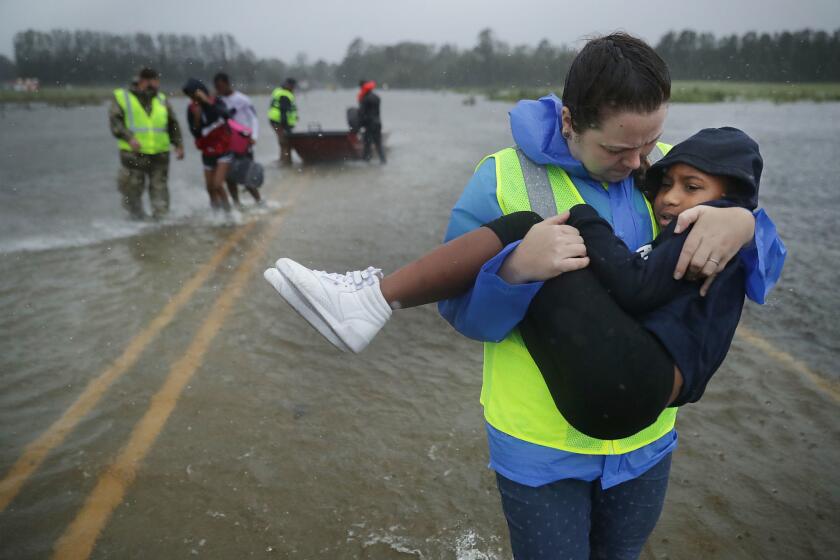 JAMES CITY, NC - SEPTEMBER 14: Volunteers from the Civilian Crisis Response Team help rescue three children from their flooded home September 14, 2018 in James City, United States. Hurricane Florence made landfall in North Carolina as a Category 1 storm and flooding from the heavy rain is forcing hundreds of people to call for emergency rescues in the area around New Bern, North Carolina, which sits at the confluence of the Nueces and Trent rivers. (Photo by Chip Somodevilla/Getty Images) ** OUTS - ELSENT, FPG, CM - OUTS * NM, PH, VA if sourced by CT, LA or MoD **