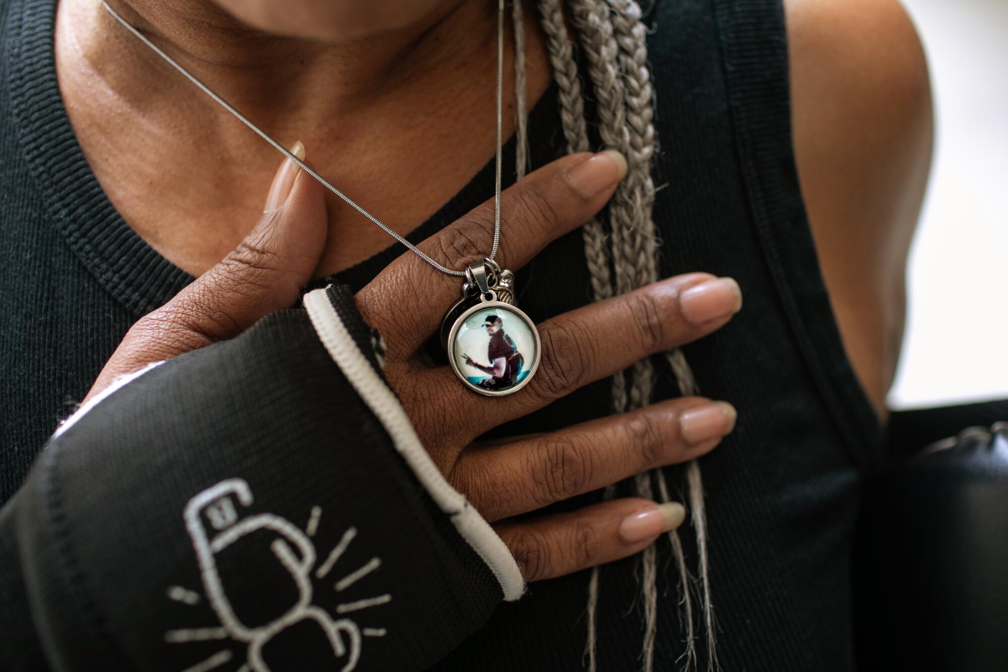 Deneen Vaughn wears a locket with a photo of her late son Chris