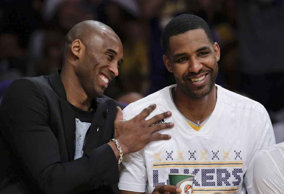 Lakers guard Kobe Bryant and forward Shawne Williams share a laugh during the Christmas Day game against the Heat.