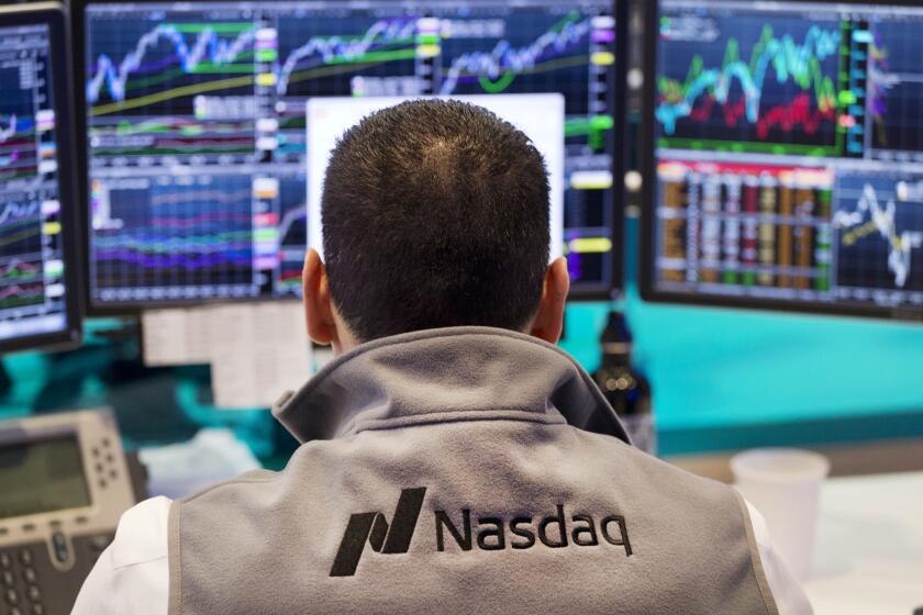 A Nasdaq employee monitors prices at the Nasdaq MarketSite in New York. The tech-driven Nasdaq hit all-time highs last month before falling hard last week.