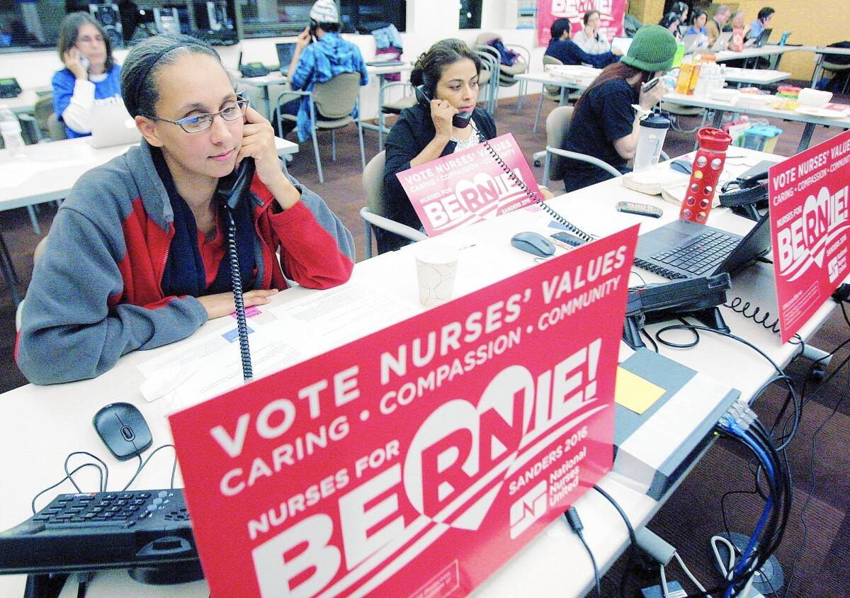 Verdugo Hills Hospital nurses Erica Beltran, left, and Dinorah Williams make calls to drum up support for their favored presidential candidate at the Glendale for Bernie Sanders headquarters. Members of National Nurses United helped staff phone banks during the evening.