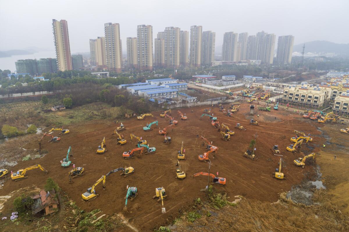 Heavy equipment works at a construction site for a field hospital Jan. 24 in Wuhan in central China's Hubei province.