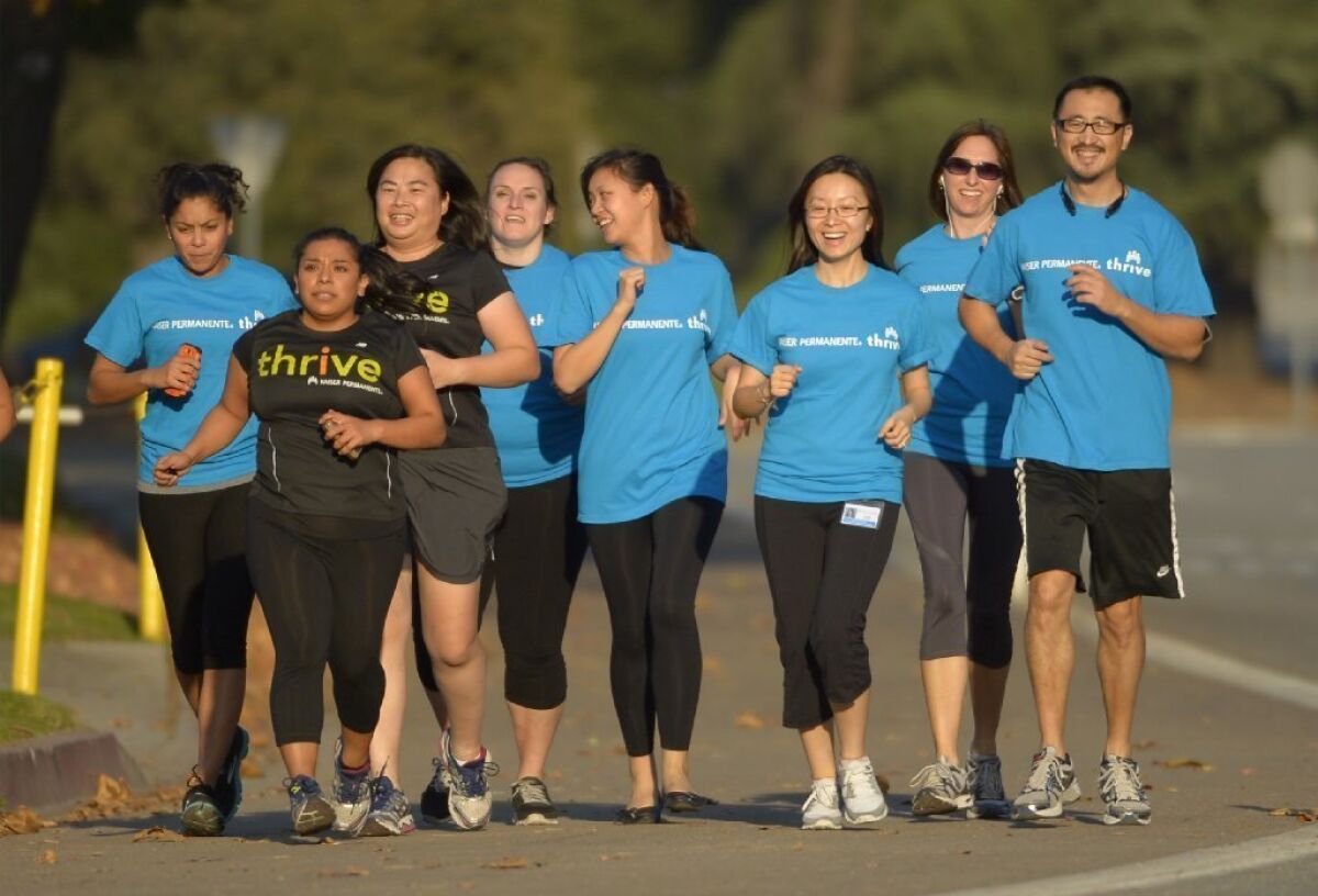 Kaiser Permanente employees exercise together in Pasadena. The nonprofit health plan has a dominant share of California employers and individual customers, research shows.