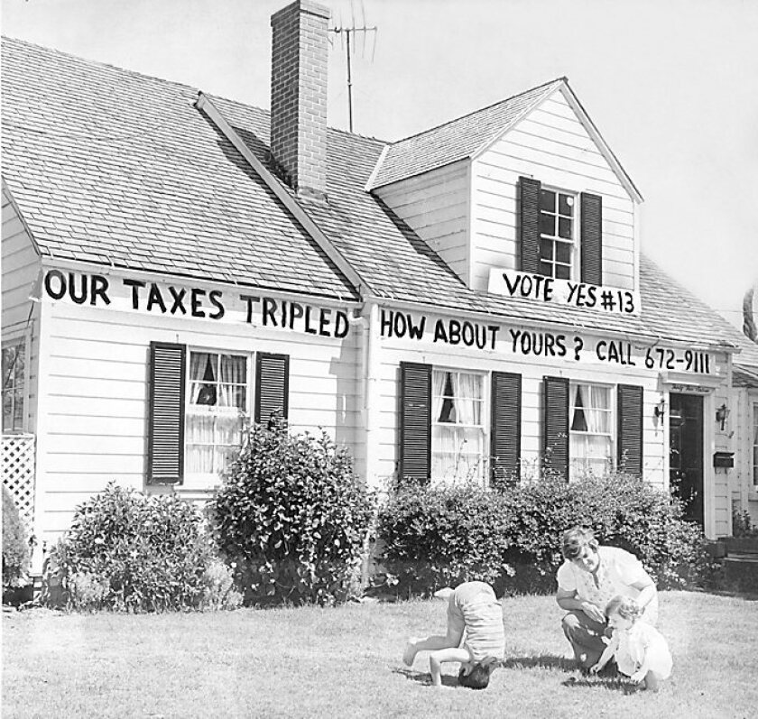 A California homeowner shows support for Proposition 13 in 1978. A recent poll found only slim support for changing the measure to exempt commercial properties from the landmark tax limitations.