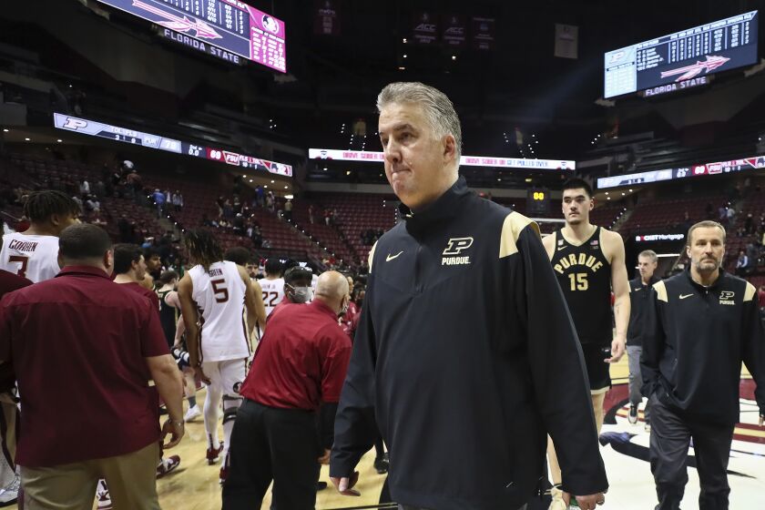 Purdue coach Matt Painter and center Zach Edey (15) walk off the court after an NCAA college basketball game against Florida State in Tallahassee, Fla., Wednesday, Nov. 30, 2022. Purdue won 79-69. (AP Photo/Phil Sears)