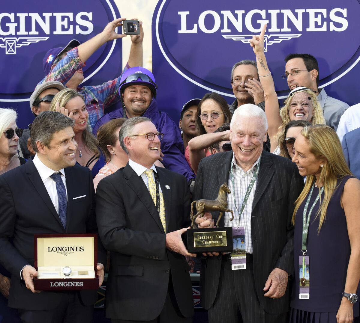 B. Wayne Hughes, second from right, celebrated after his horse won at Santa Anita in 2016. 