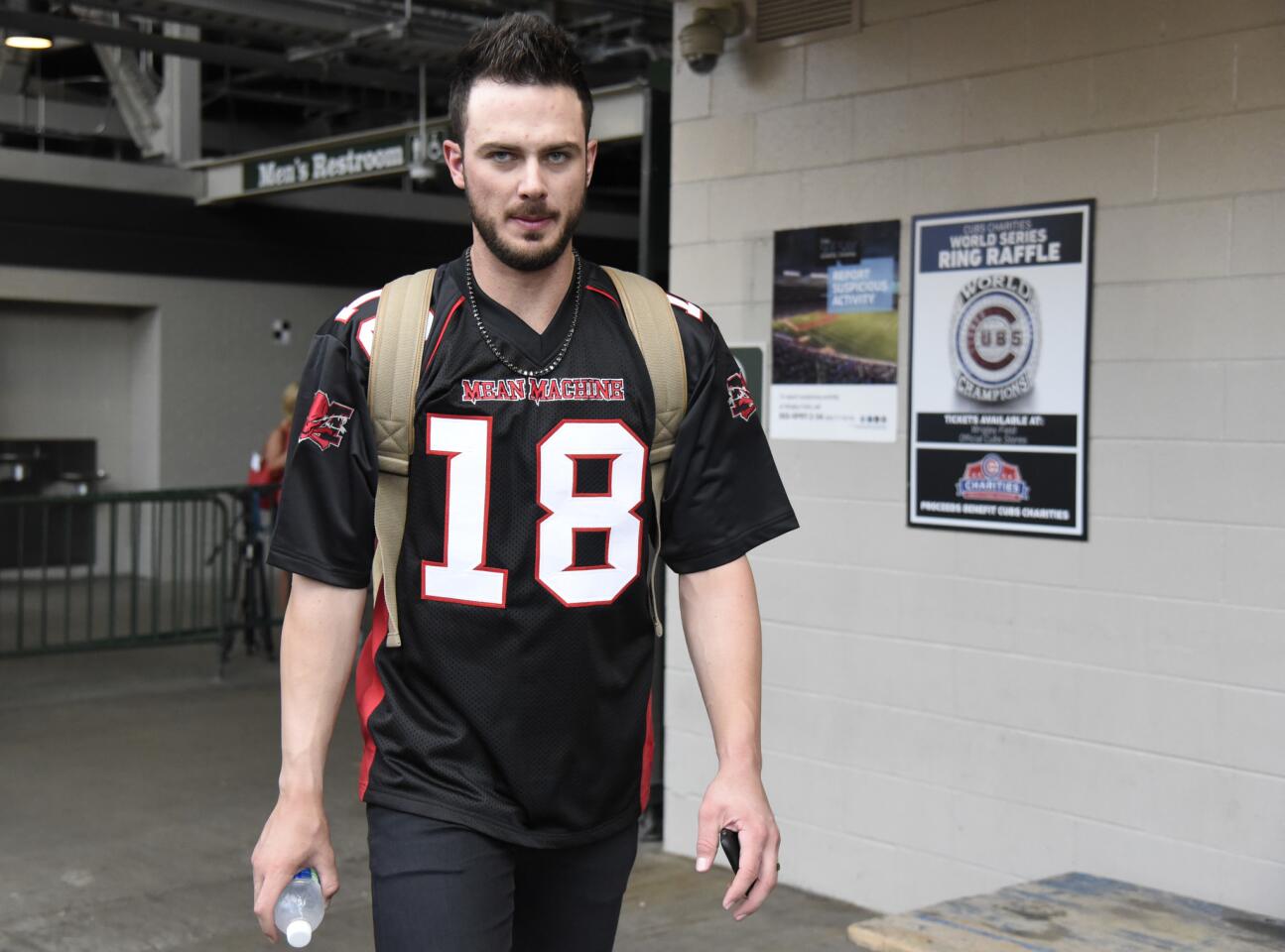 Kris Bryant wears a football jersey as the Cubs leave on their road trip on Sept. 3, 2017.