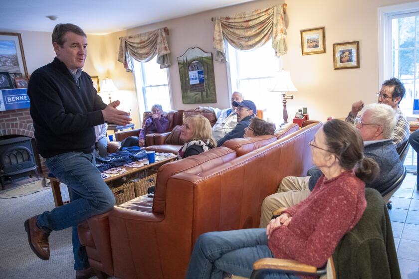 Democratic presidential candidate Sen. Michael Bennet, D-Colo., speaks to guest at a house party in Chester, N.H, Sunday, Jan. 26, 2020. (AP Photo/Mary Altaffer)