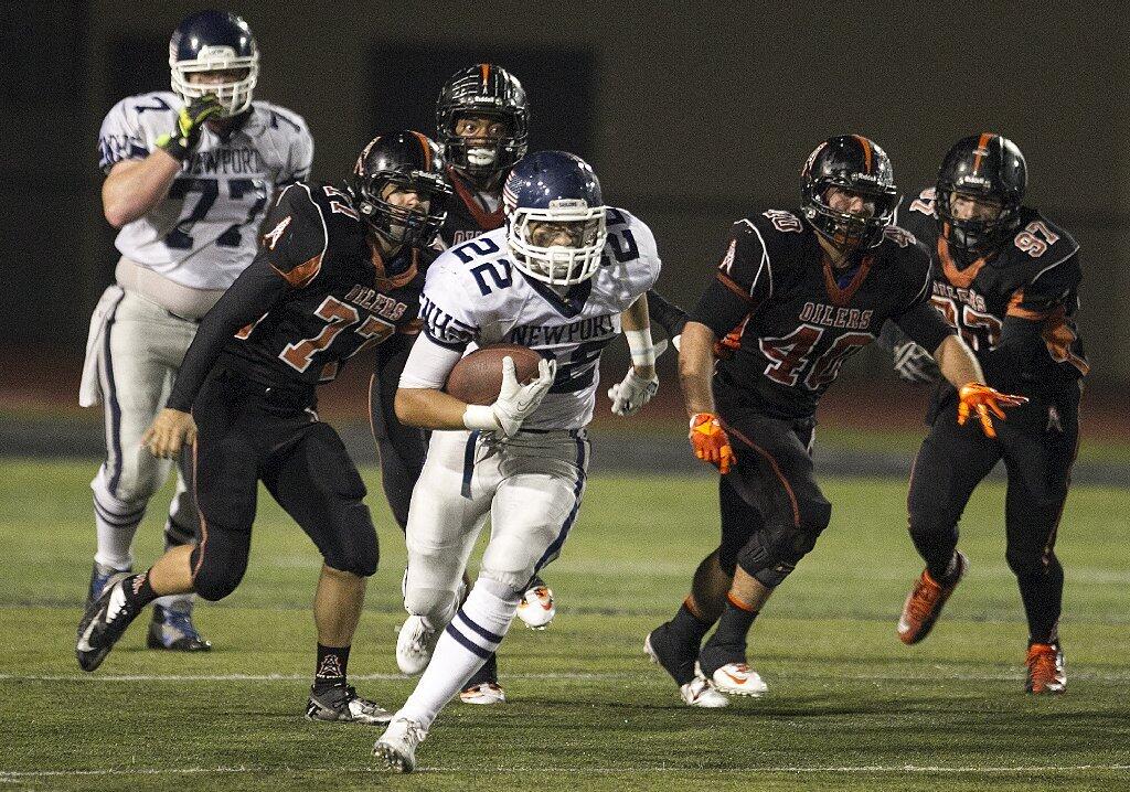 Newport Harbor's Max Durante runs upfield in the fourth quarter against Huntington Beach during a game on Friday.