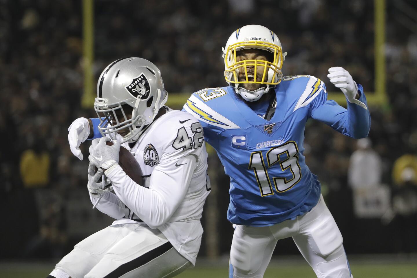 Raiders strong safety Karl Joseph (42) defends a pass intended for Chargers receiver Keenan Allen (13) during the first half of a game Nov. 7 at RingCentral Coliseum.