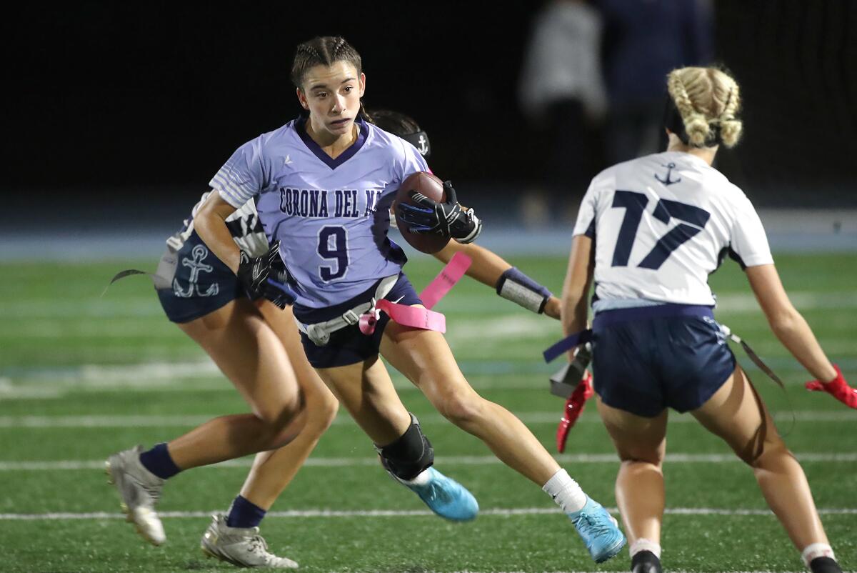 Corona del Mar's Addison Stern (9) runs through the defense for a gain against Newport Harbor on Monday night.