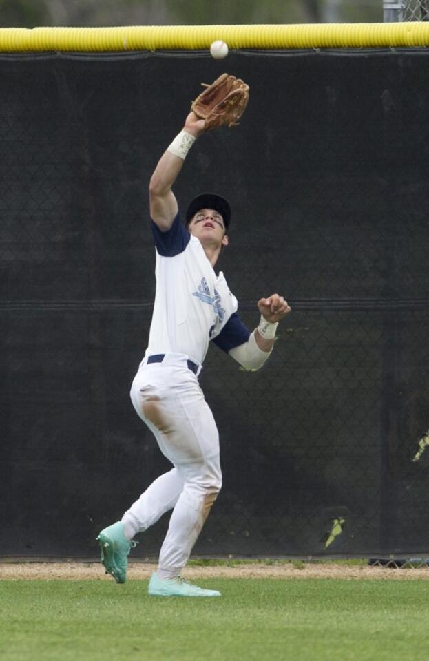 Corona del Mar's Preston Hartsell catches a fly ball in deep center field by Woodbridge's Towns King.