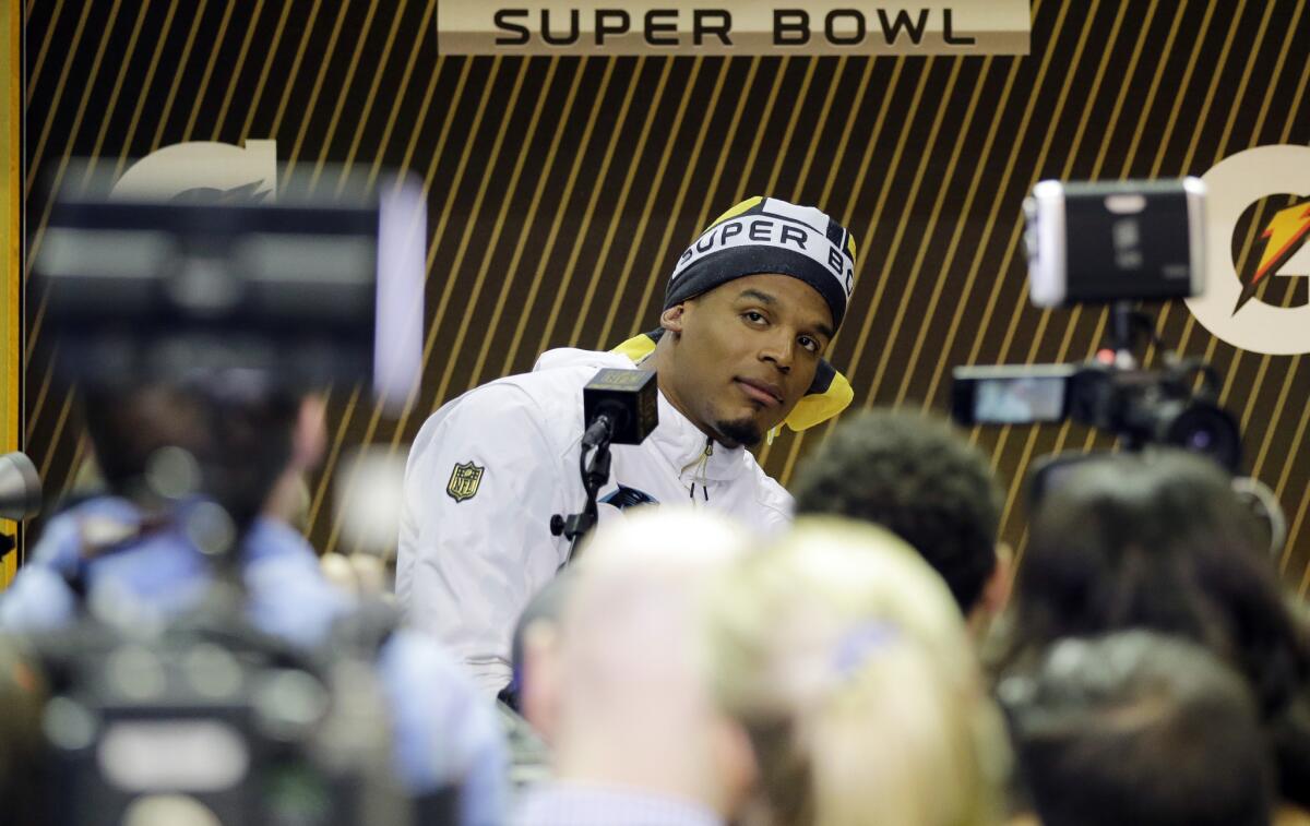 Panthers quarterback Cam Newton answers a question during the first day of media questioning prior to Super Bowl 50.