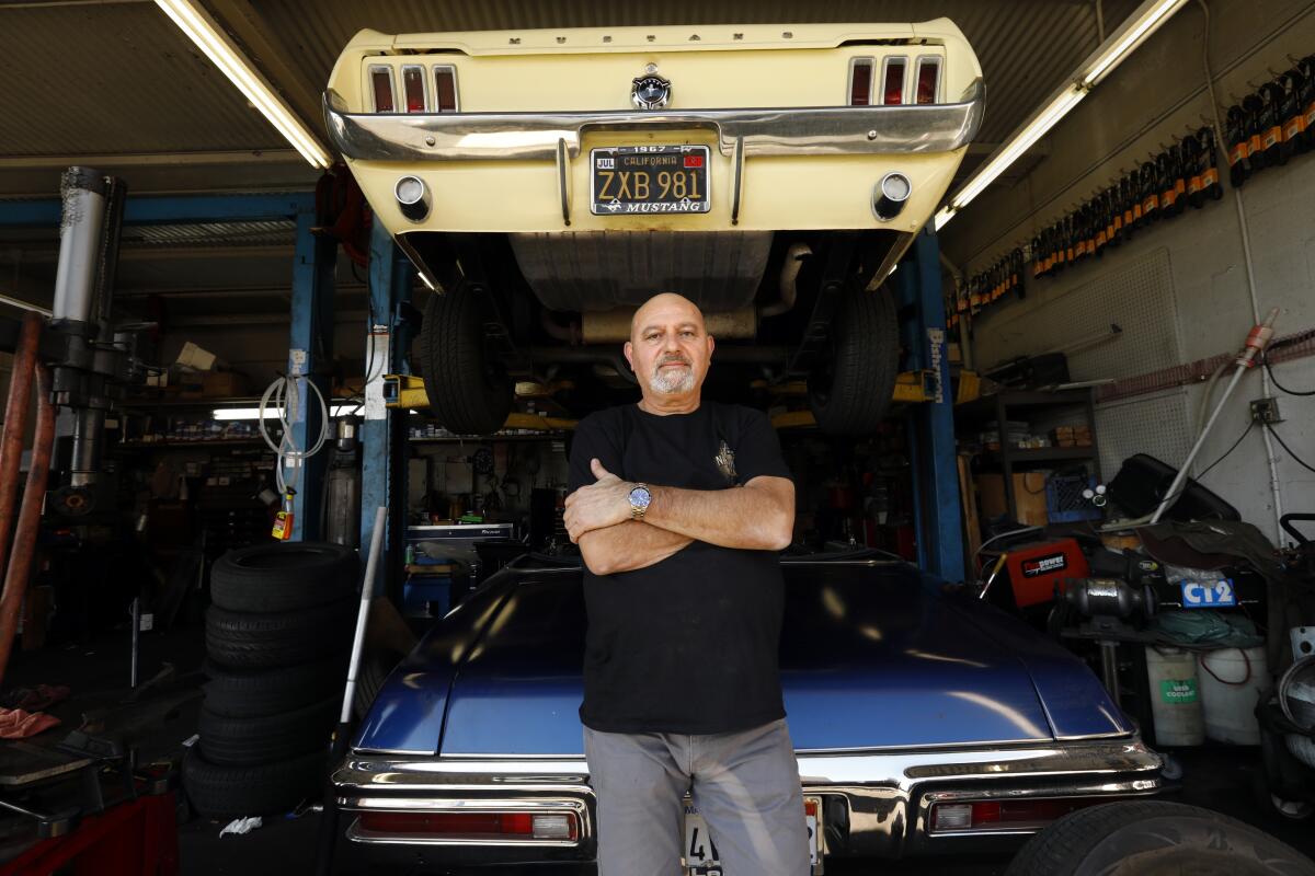 Hagop Berberian, owner of Allright Automotive in Inglewood, with one of his personal cars, a 1967 Mustang.