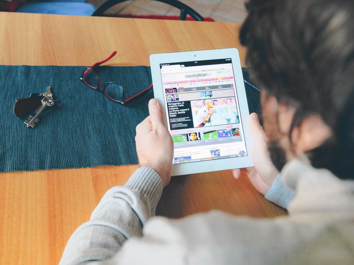 Publishers are struggling to get readers to subscribe to digital magazines delivered to their tablets and phones. Above, a man reads an article on his iPad.