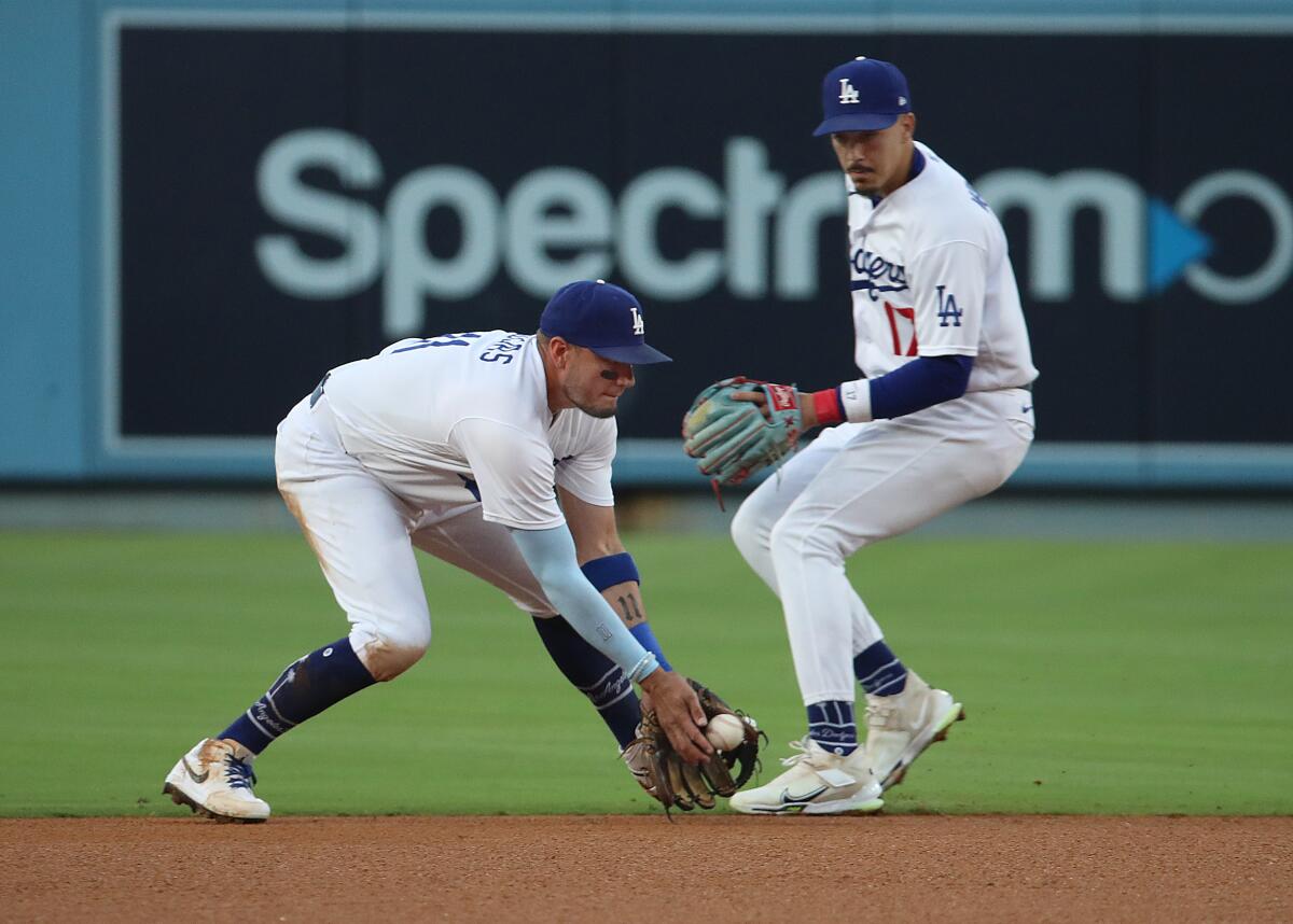 Dodgers shortstop Miguel Rojas fields a single by Houston's Chas McCormick in front of second baseman Miguel Vargas.