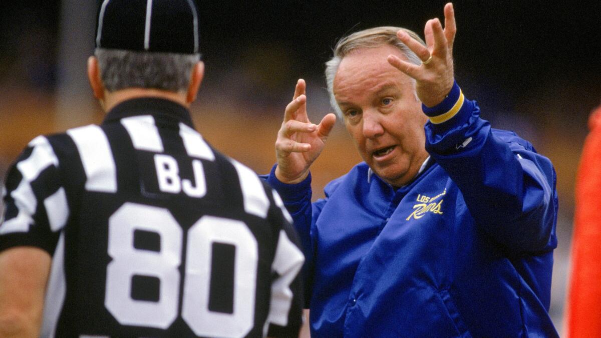 Rams Coach John Robinson argues a call with an official during a game against the Falcons on Dec. 8, 1991.