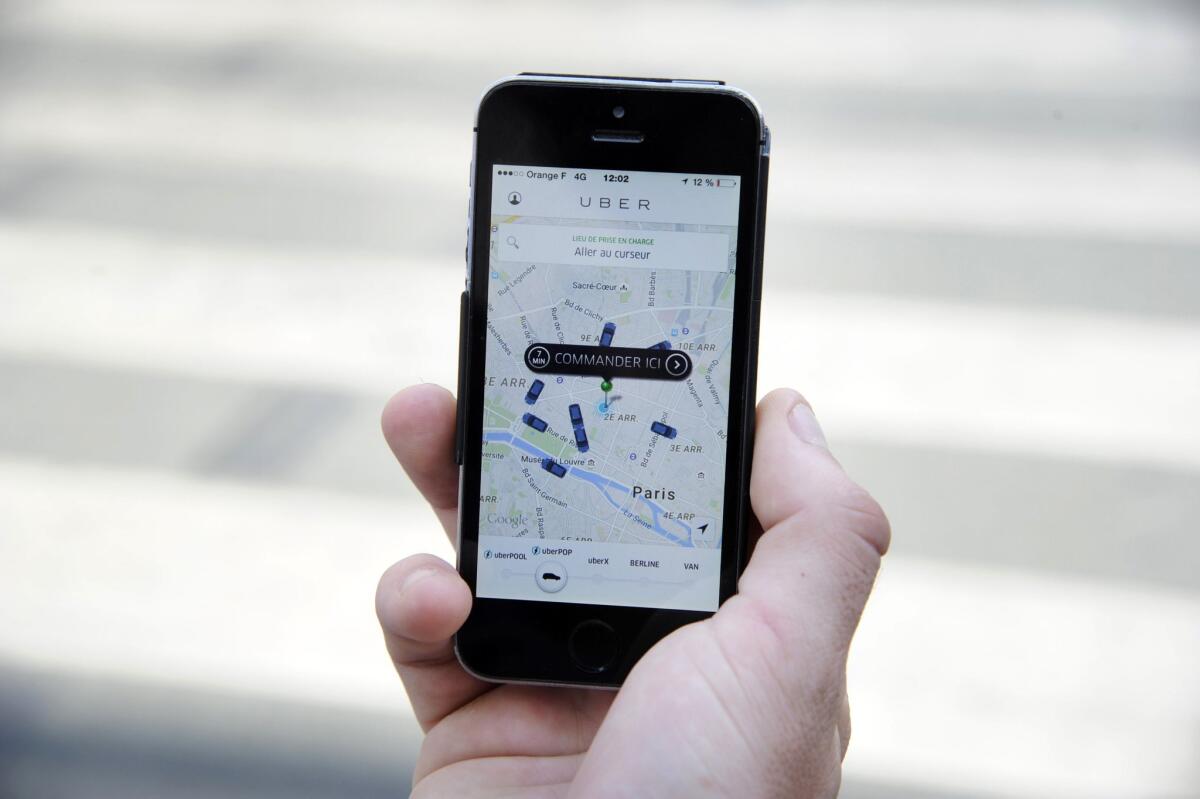 The Uber app open on a phone. The San Francisco company has been expanding its operations around the world.