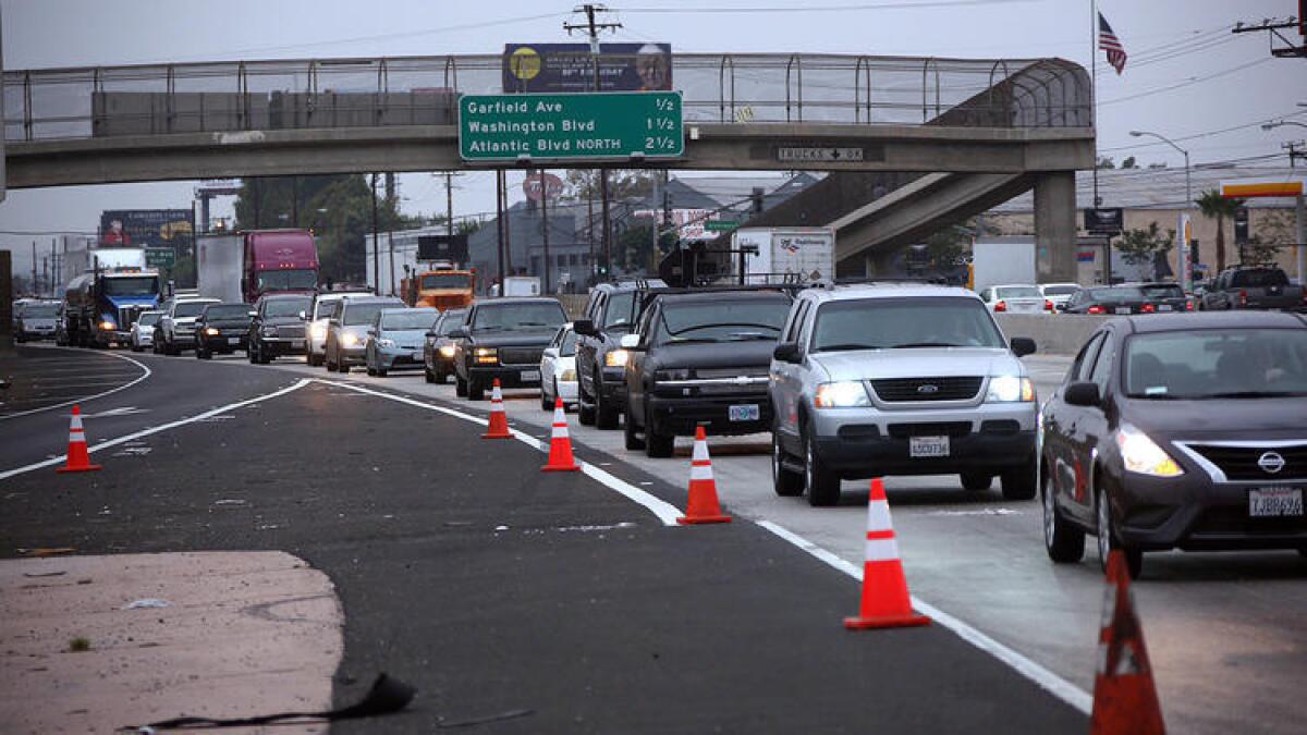 Three lanes of the southbound 5 Freeway remained closed in the City of Commerce on Wednesday, more than day after a fire broke out along a riverbed and snarled traffic on both sides of the busy roadway.