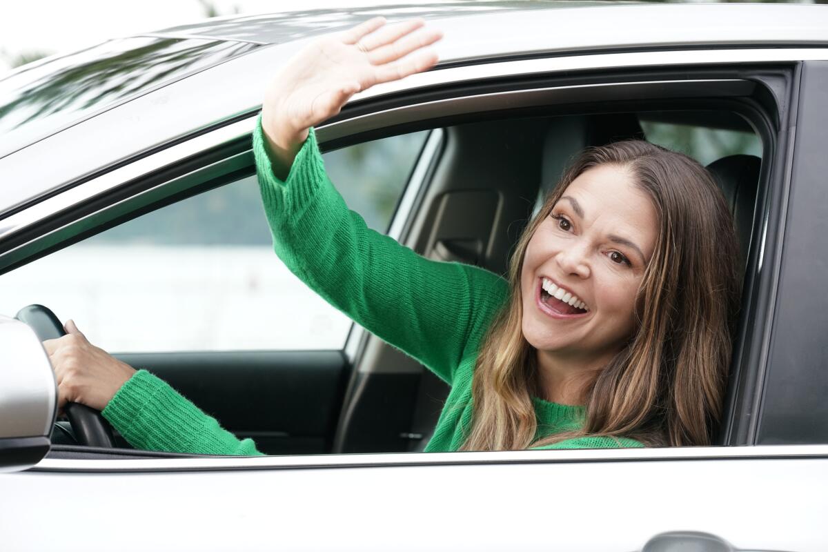 Sutton Foster in "Younger," waving out of a care window