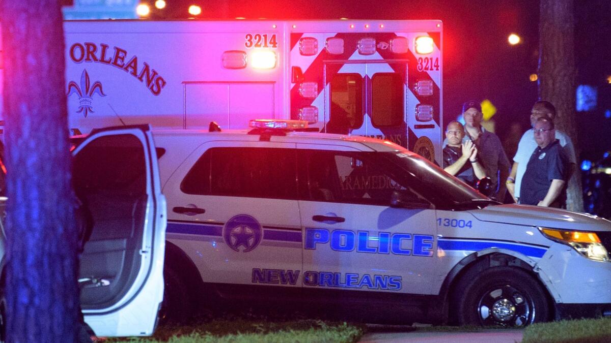 A suspect in the shooting death of a New Orleans police officer is taken away in an ambulance on Oct. 13.