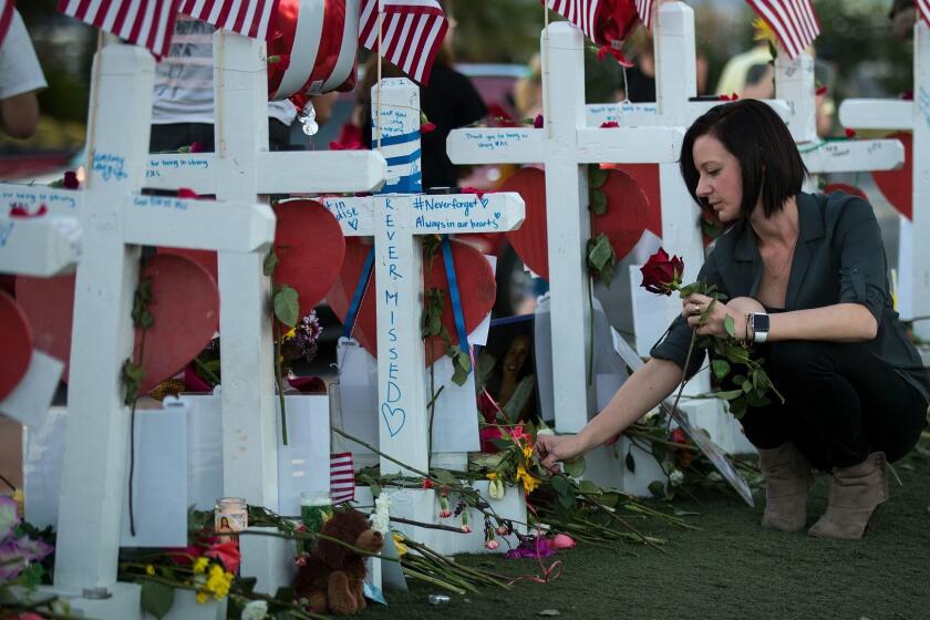 LAS VEGAS, NV - OCTOBER 6: Antoinette Cannon, who worked as a trauma nurse and treated victims last Sunday night, leaves a rose at each of the 58 white crosses at a makeshift memorial on the south end of the Las Vegas Strip, October 6, 2017 in Las Vegas, Nevada. On October 1, Stephen Paddock opened fire on the crowd at the Route 91 Harvest country music festival, killing 58 people and injuring more than 450. The massacre is one of the deadliest mass shooting events in U.S. history. (Photo by Drew Angerer/Getty Images) ** OUTS - ELSENT, FPG, CM - OUTS * NM, PH, VA if sourced by CT, LA or MoD **