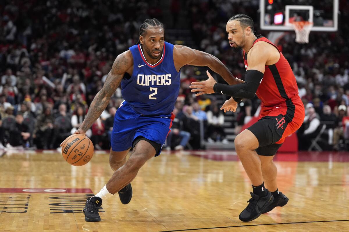 The Clippers' Kawhi Leonard drives past the Rockets' Dillon Brooks Wednesday in Houston