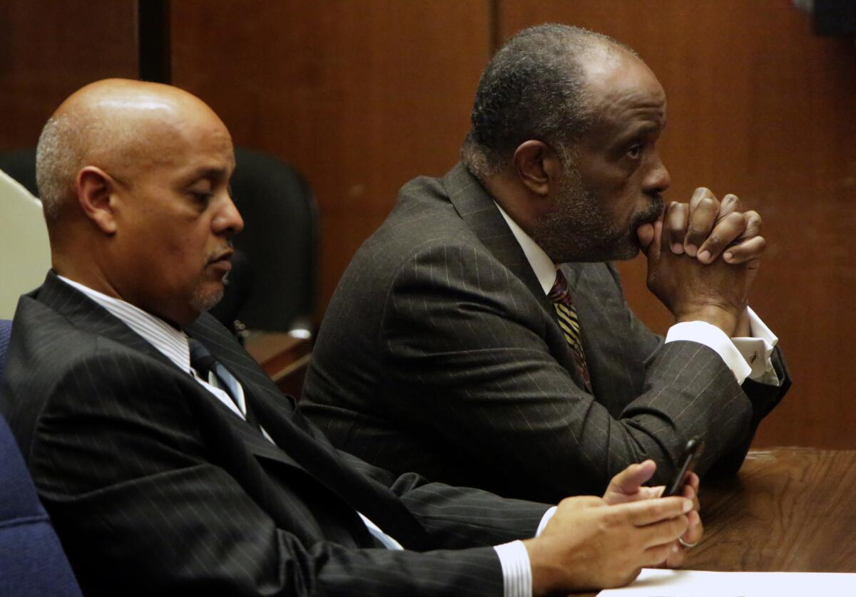 State Sen. Roderick Wright, with his attorney Winston Kevin McKesson, left, listens to a judge after jury convicted him in January of fraud and perjury for living outside his Senate district.