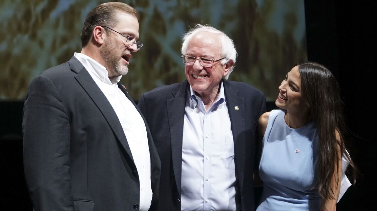Sen. Bernie Sanders and Alexandria Ocasio-Cortez appear at a campaign rally in Wichita for Kansas congressional candidate James Thompson, left, on July 20.