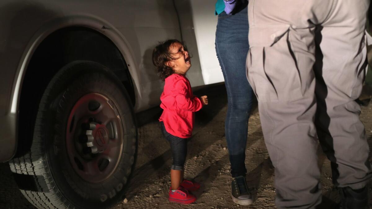 This image of a 2-year-old Honduran girl crying as her mother is searched at the border has come to symbolize the separation of migrant families under President Trump's immigration policy. This girl, however, was not among those children separated from their parents.