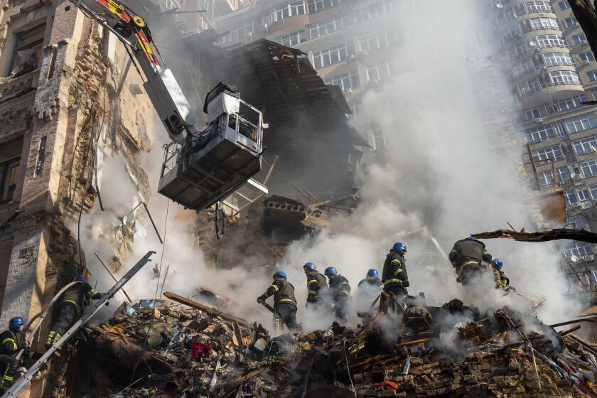 Firefighters work after a drone attack on buildings in Kyiv, Ukraine, Monday, Oct. 17, 2022. (AP Photo/Roman Hrytsyna)