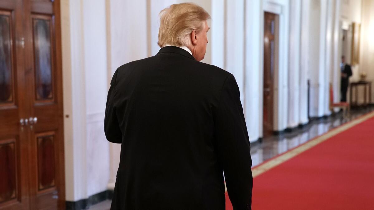 President Trump walks out of the East Room of the White House on May 22.