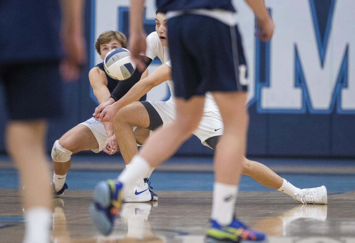 Corona del Mar High's Jaden Glenn, left, shown digging a ball against Los Angeles Loyola on Feb. 26, was an all-tournament team selection at the Best of the West boys' volleyball tournament.